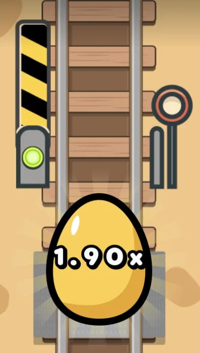 Chicken Train golden egg on the tracks with a train approaching in the background